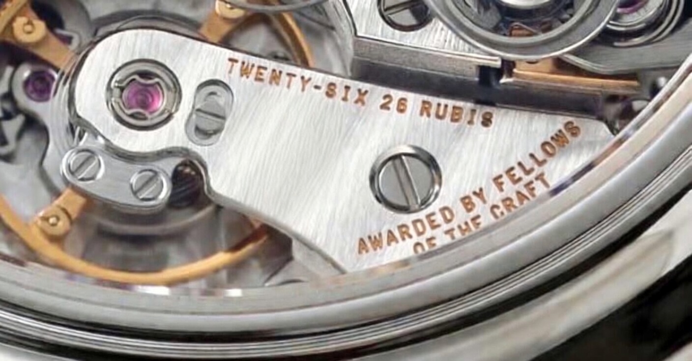 Close-up artwork of an engraved watch movement